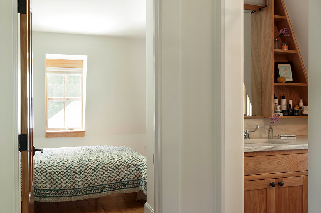 picture of another bedroom and small bathroom with custom shelves