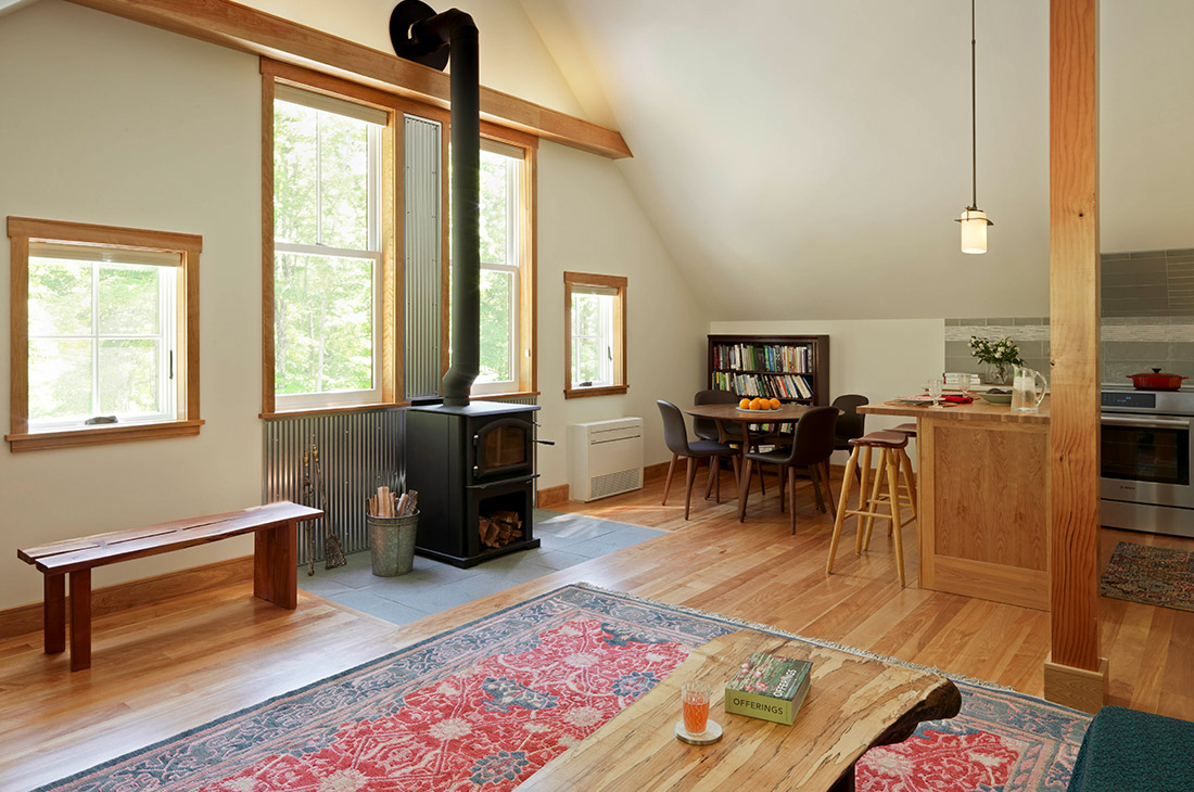 picture of the dining area with woodstove with large windows