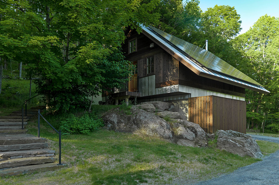 picture of the exterior of the home slid into the rock
