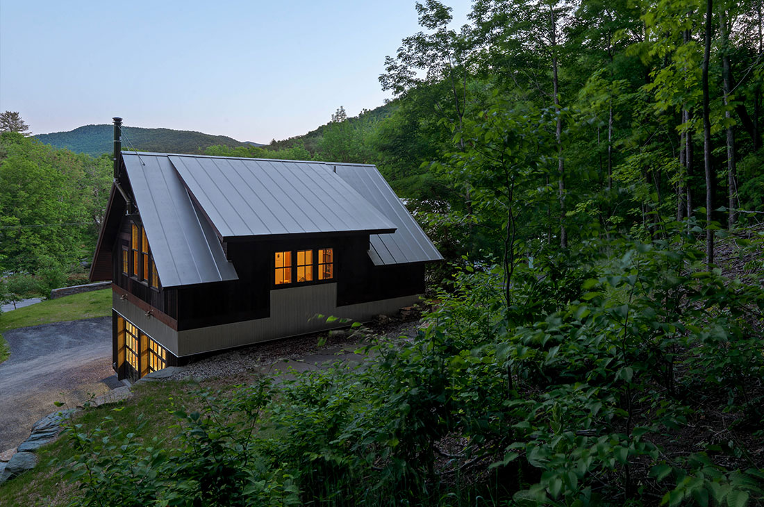 picture of the back of the home with dormer and mountain view