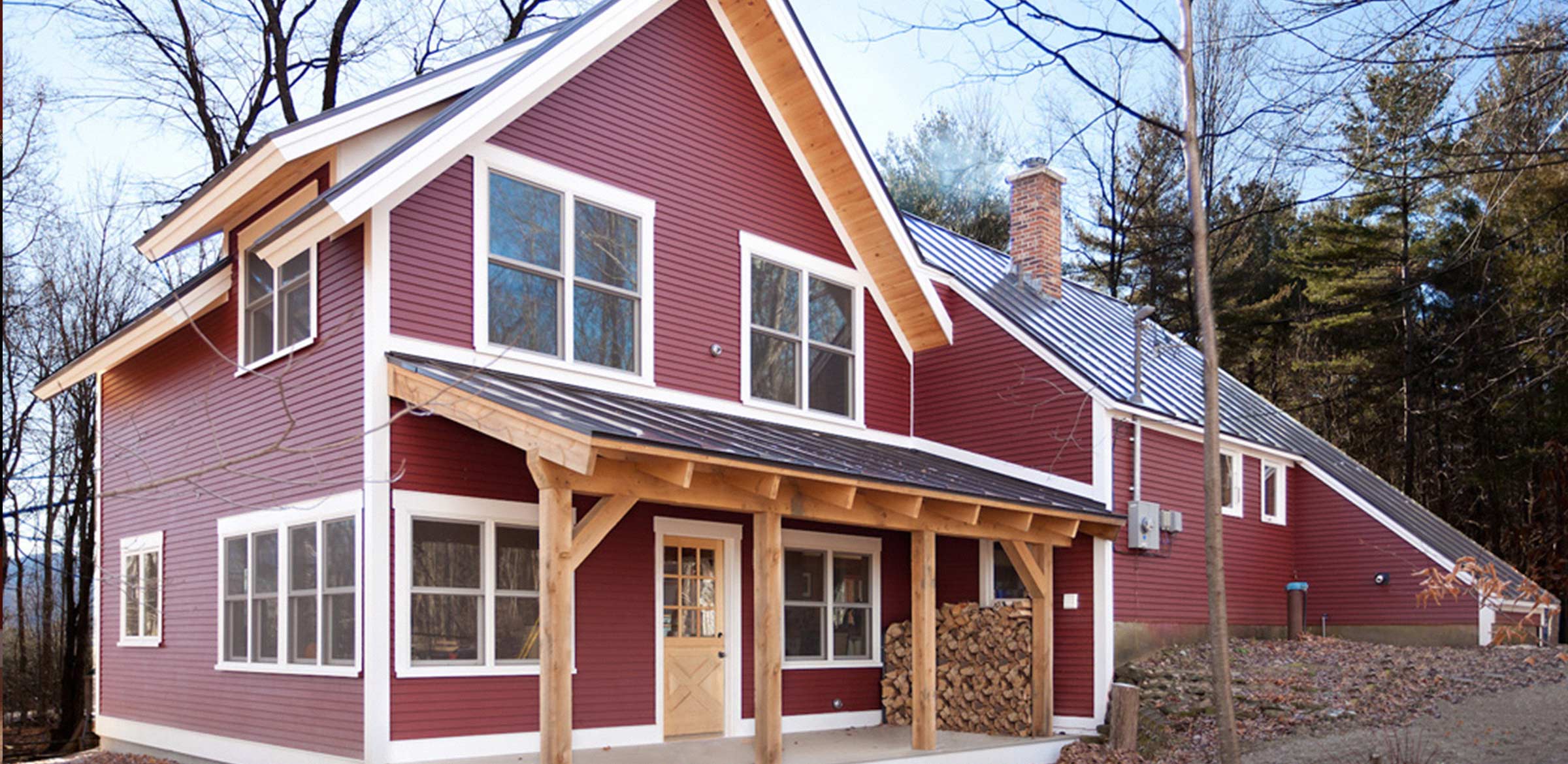 a red home with timber deck