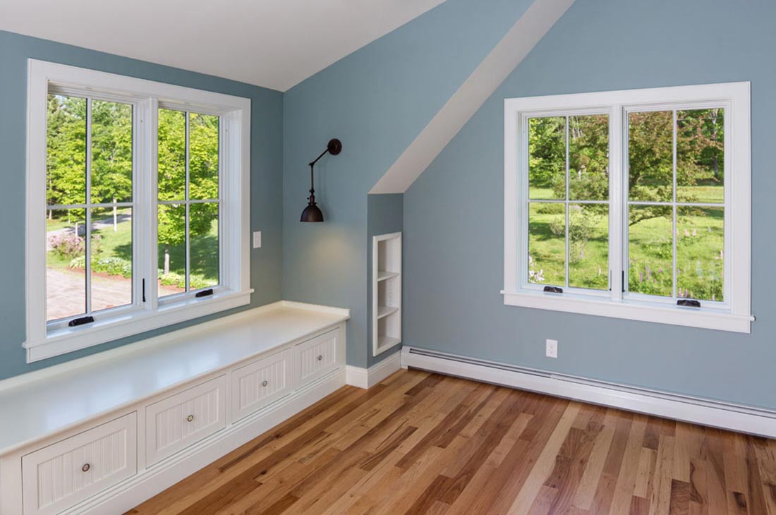 blue bedroom with built in shelves and bench seat