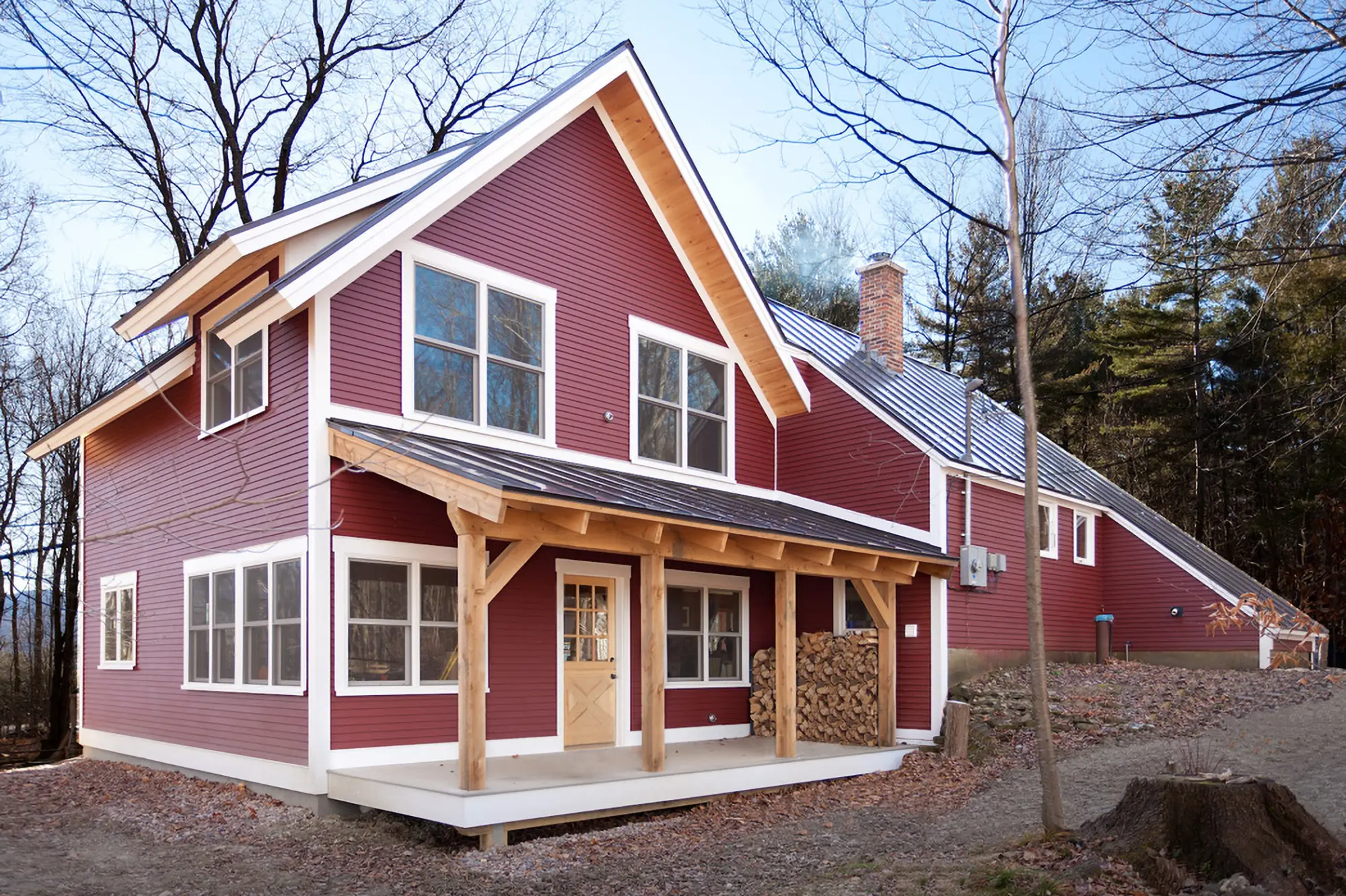 a red home with timber deck