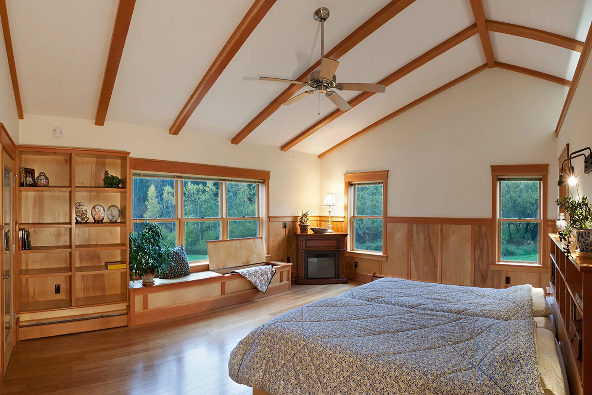 master bedroom with built in bench and exposed beams