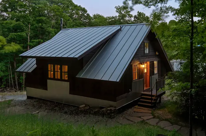 small home on a hill side an trees